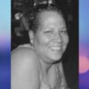 Black-and-white photo of a woman smiling warmly at the camera
