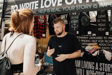 Woman buying band merch at the concert