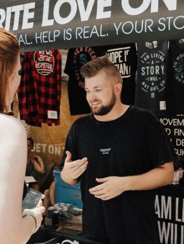 Woman buying band merch at the concert