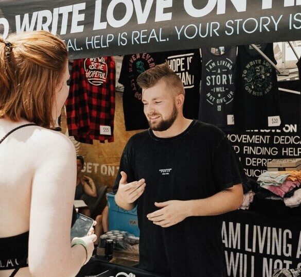 Woman buying band merch at the concert