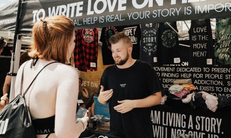 Woman buying band merch at the concert