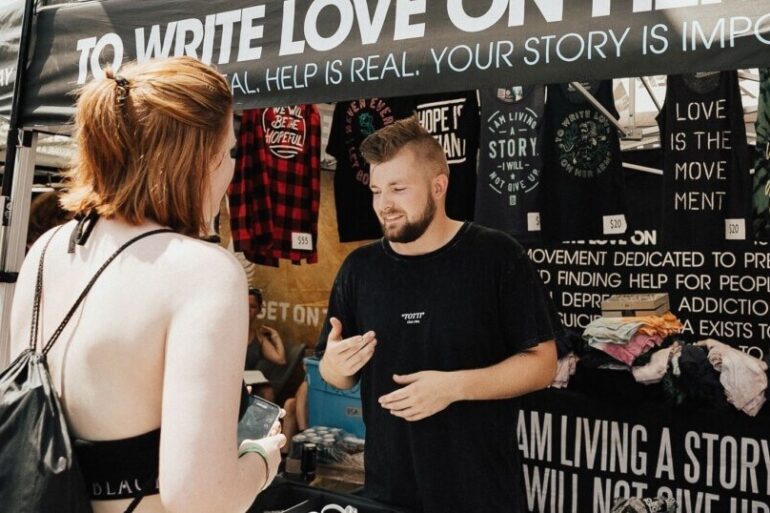 Woman buying band merch at the concert