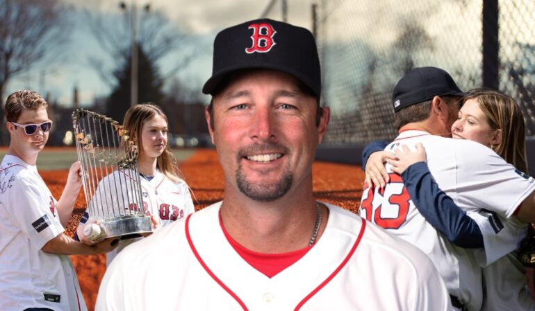 Baseball player in a Red Sox uniform smiling, with family and a championship trophy in the background