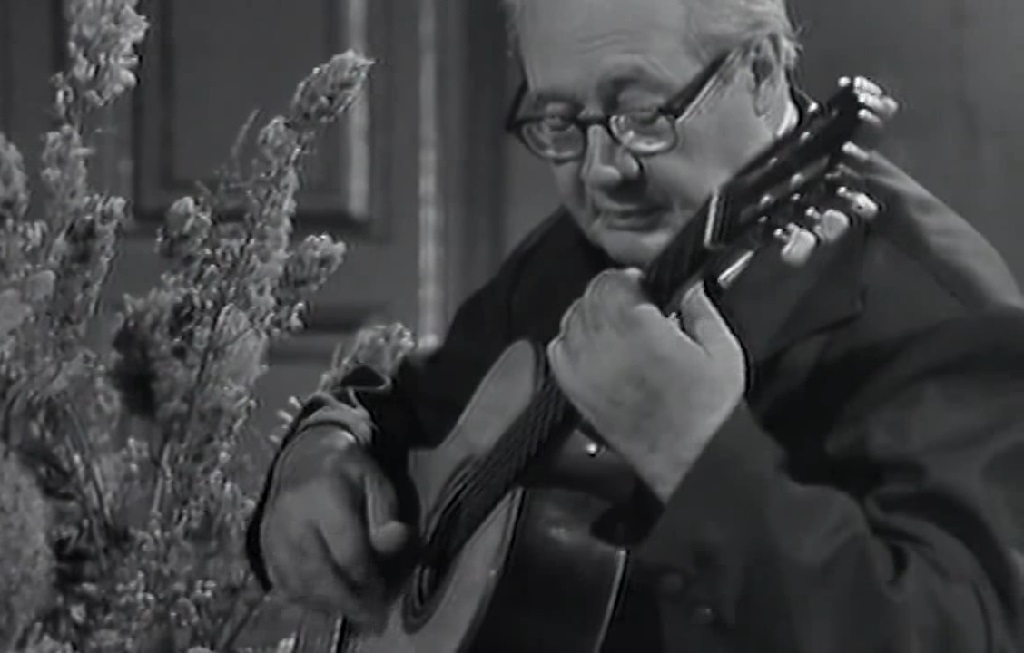 Black-and-white image of Andrés Segovia playing guitar