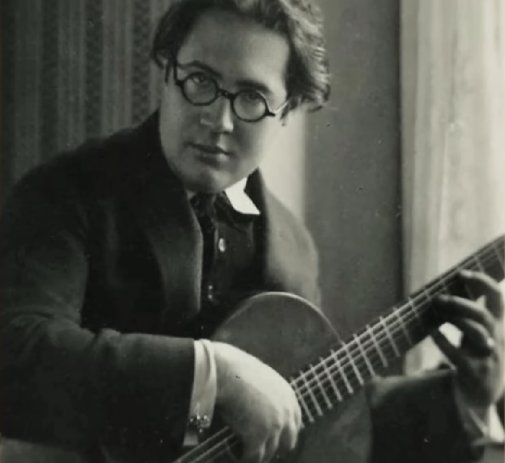 Black-and-white photograph of young Andrés Segovia playing the guitar