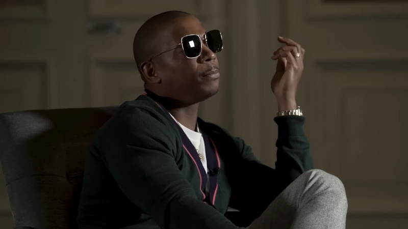Ja Rule sits in a chair wearing sunglasses during an interview