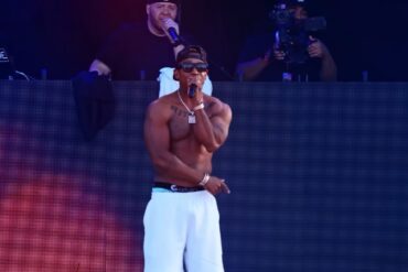 Ja Rule performs shirtless on stage during a 2025 concert