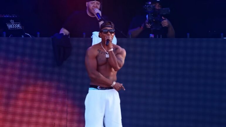 Ja Rule performs shirtless on stage during a 2025 concert