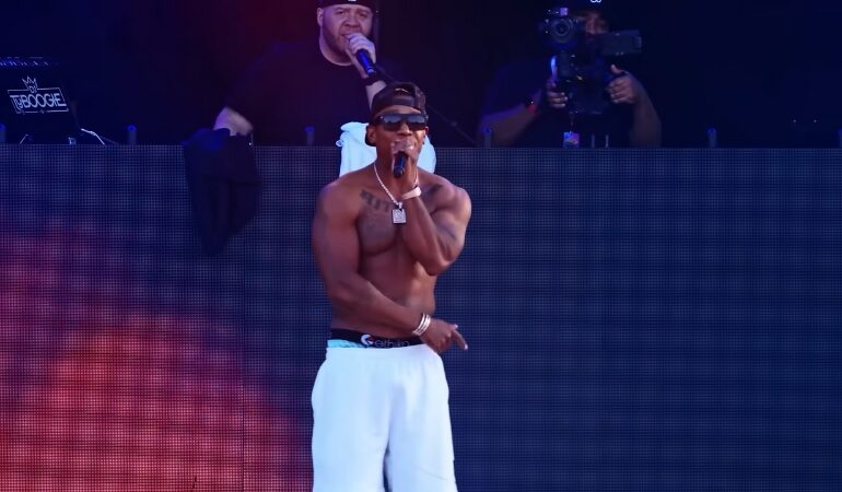 Ja Rule performs shirtless on stage during a 2025 concert