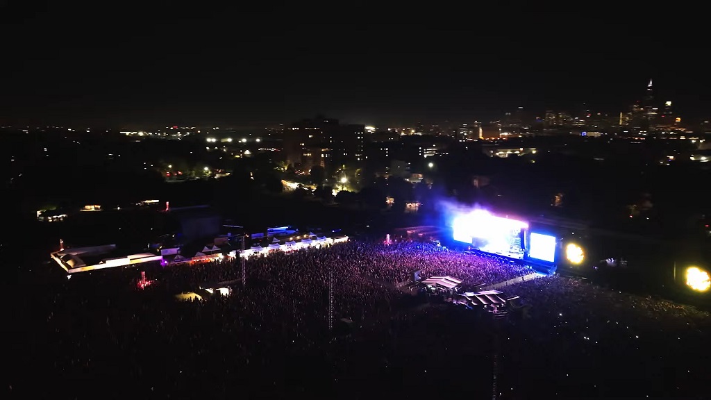 Aerial night view of Riot Fest at Douglass Park, Chicago, with massive crowds lit up by the main stage