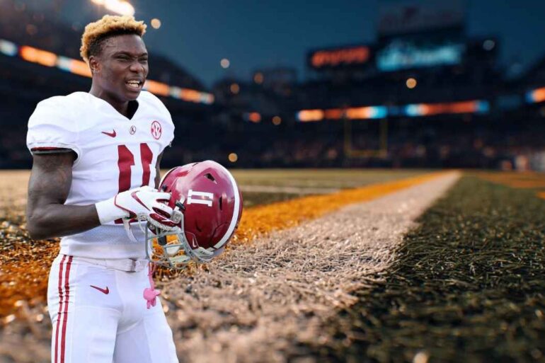 Henry Ruggs in an Alabama football uniform holding his helmet on the sideline of a stadium