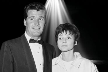 Black-and-white photo of James Garner and his wife Lois Clarke standing together under a spotlight