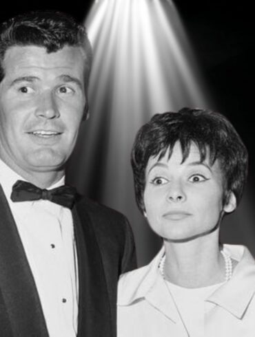 Black-and-white photo of James Garner and his wife Lois Clarke standing together under a spotlight