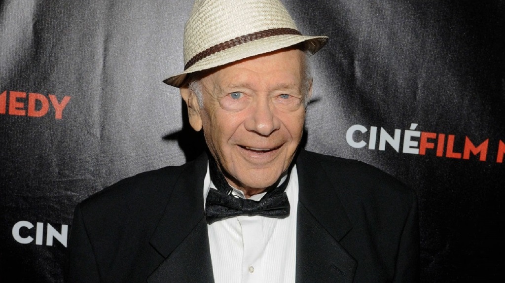 The Final Encore: Retired Celebrities Find a Stage at the Lillian Booth Actors' Home An elderly man dressed in a tuxedo and hat smiles at a film event, known as a resident of the Lillian Booth Actors Home