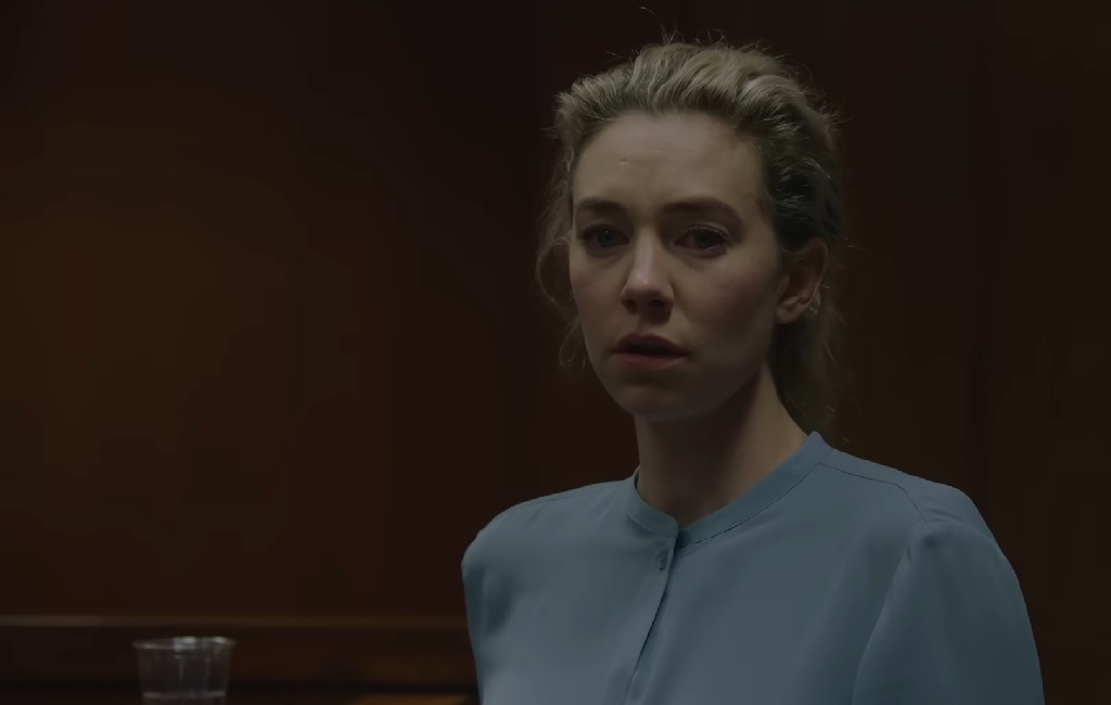 The Many Faces of Vanessa Kirby: Princess Margaret, Grieving Mother in Pieces of a Woman, and Marvel Icon Vanessa Kirby as Martha in Pieces of a Woman, standing in a dimly lit courtroom, wearing a pale blue blouse with a somber, tearful expression.