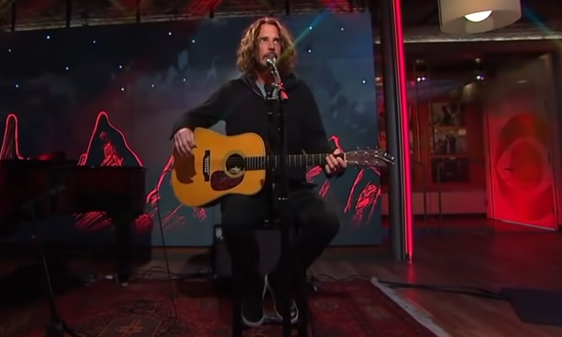 Chris Cornell playing a guitar on a TV studio stage