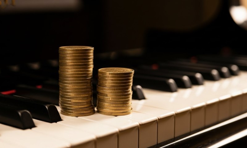 Two stacks of coins on a piano