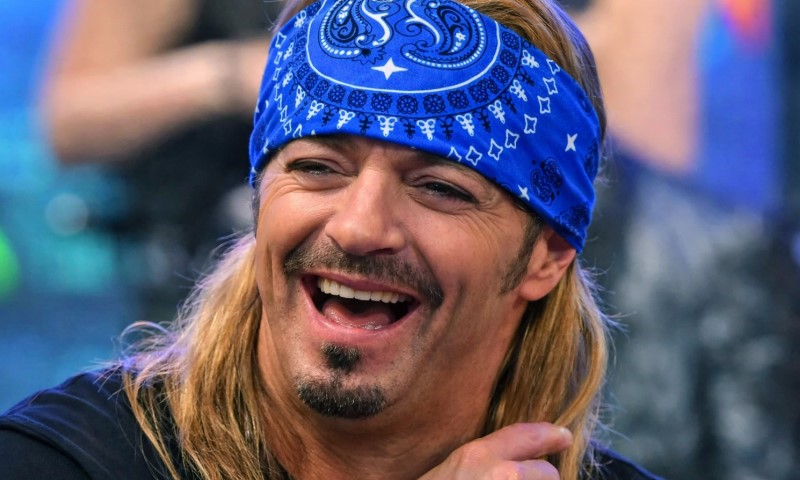 The Bandana in Rock Culture: 10 Iconic Moments That Defined a Generation Bret Michaels with long blonde hair and a blue bandana laughs joyfully