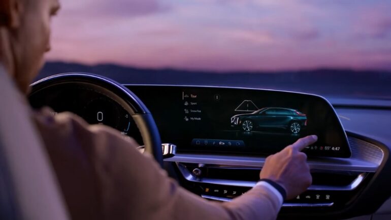 Do the Driving Modes in the Cadillac Lyriq Offer Different Ranges or Battery Usages? Driver selecting a driving mode on the Cadillac Lyriq infotainment screen