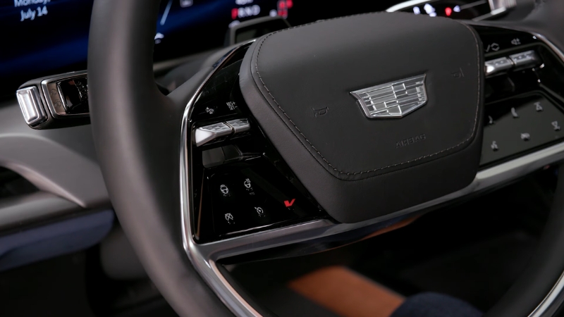 Do the Driving Modes in the Cadillac Lyriq Offer Different Ranges or Battery Usages? Cadillac Lyriq steering wheel and dashboard controls inside the electric SUV