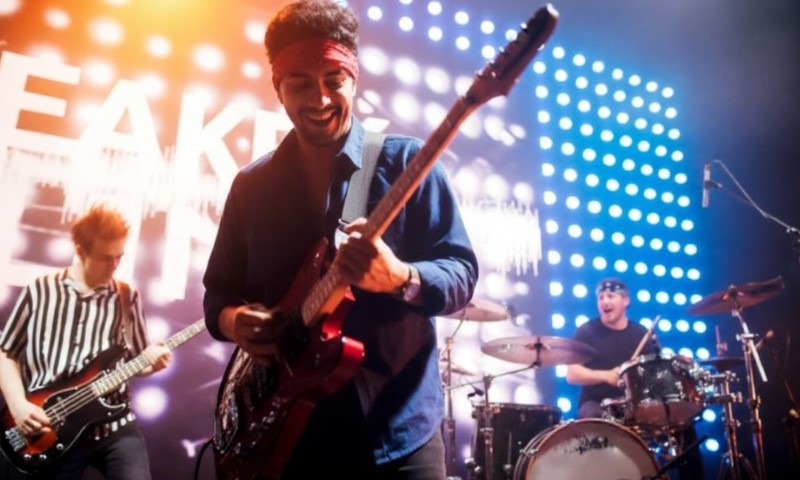 The Bandana in Rock Culture: 10 Iconic Moments That Defined a Generation A lively band performs on stage with dynamic LED lights