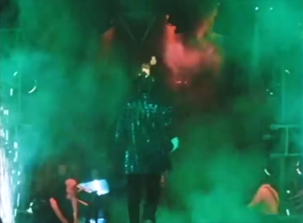 Michael Jackson performing on stage during a pyrotechnic accident where his hair caught fire during a concert performance