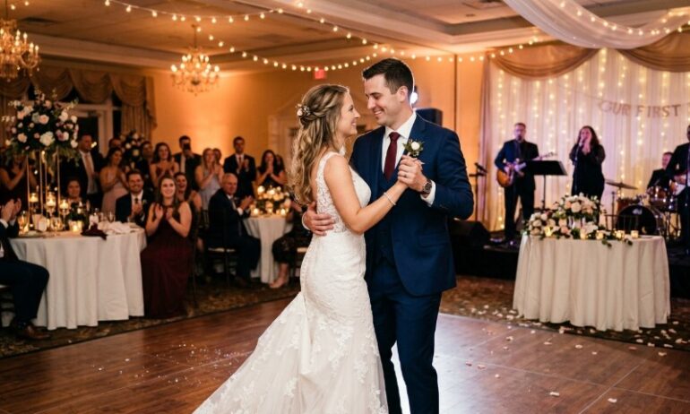 Best Songs For A Modern Wedding: Music Ideas Guests Will Enjoy A bride in a lace gown and groom in a navy suit share a joyful first dance