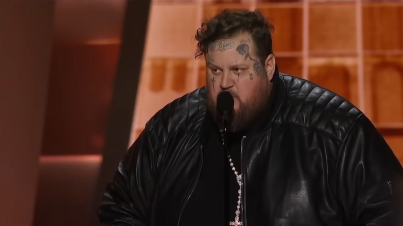 Jelly Roll Bio - Age, Family, Marriage and Fame Jelly Roll speaks into a microphone on an orange-lit stage