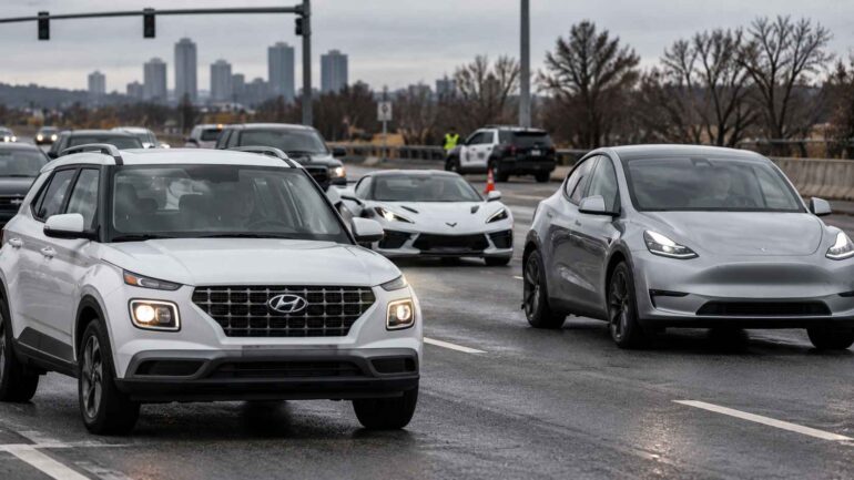 Hyundai Venue, Chevrolet Corvette and Tesla Model Y driving on a wet American city road.