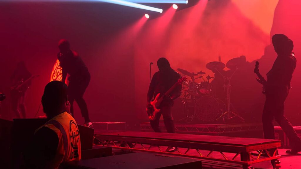 Heavy metal band performing under red lights at Damnation Festival in Manchester