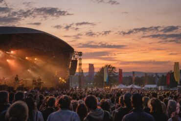 Crowd watching a live music festival at sunset in the UK