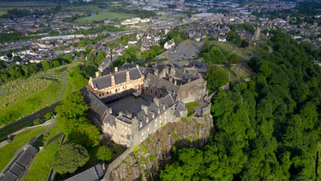 Aerial view of Stirling Castle perched on a rocky hill overlooking the historic Scottish city.